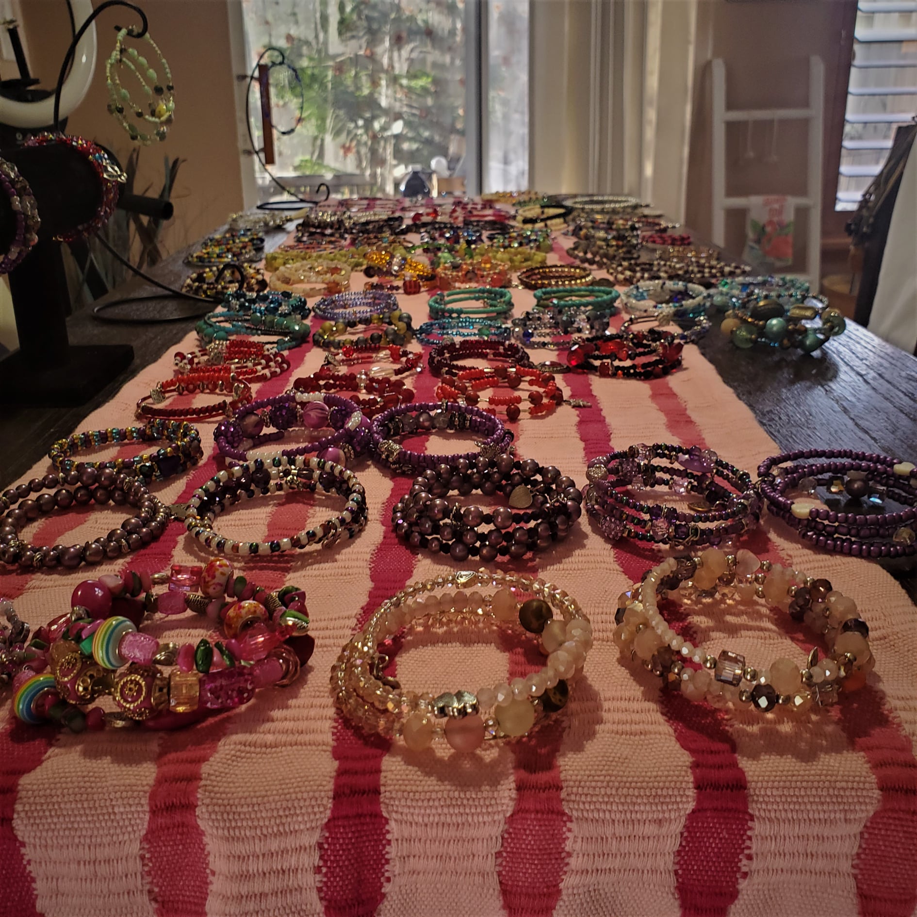 a table covered in beaded bracelets