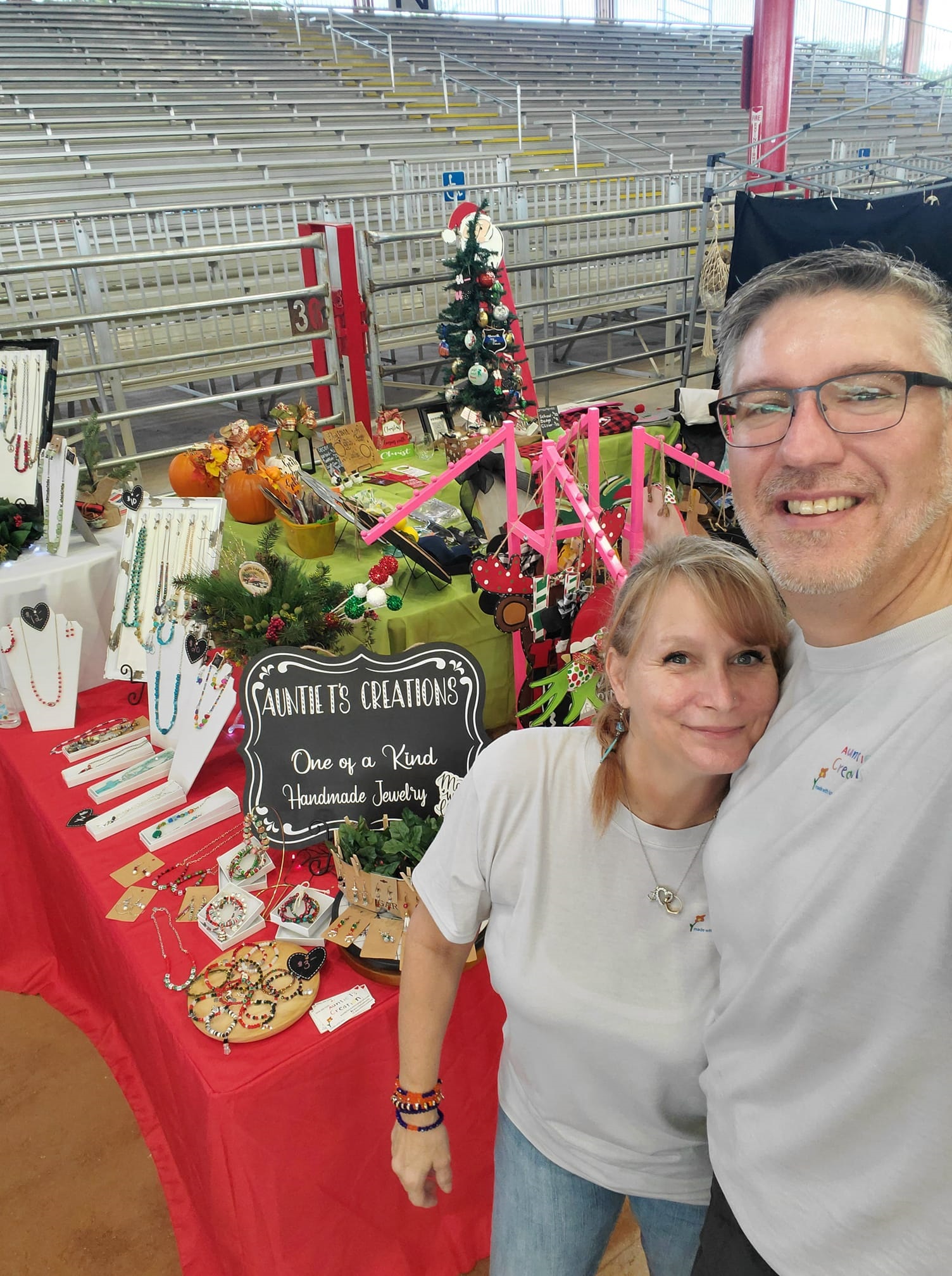 Autnie T and her husband in their booth at a craft show