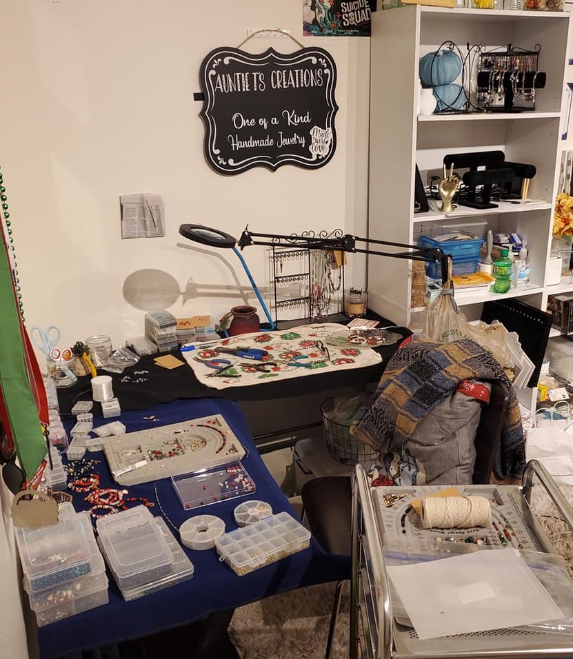 Auntie T's studio, a desk covered in beads and jewelry-making equipment